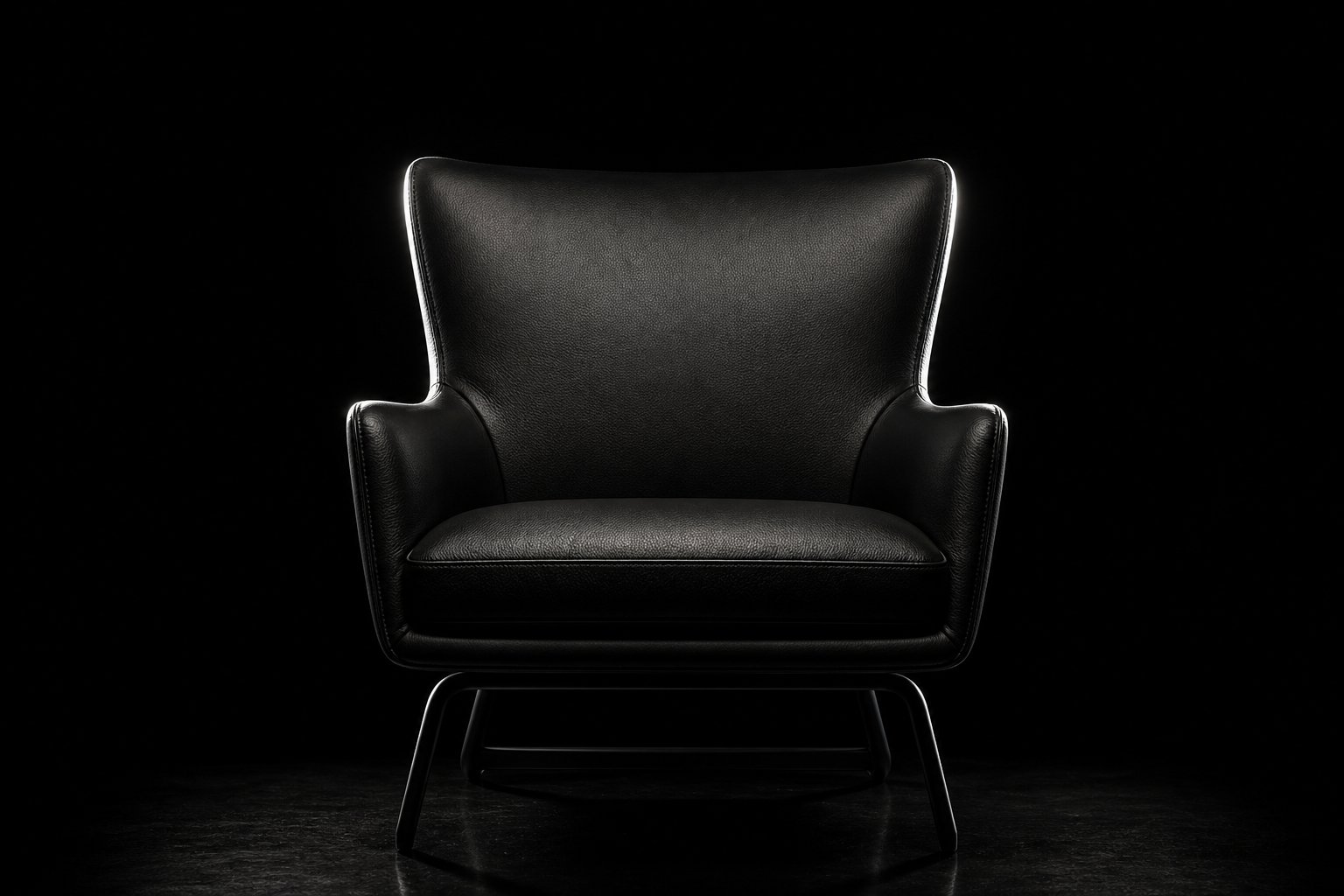 Dark armchair traced by rim light on black — low-key rim study